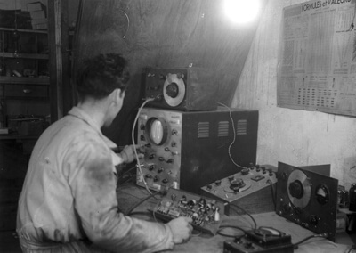 Jean Guen checking the voltage of an amplifier